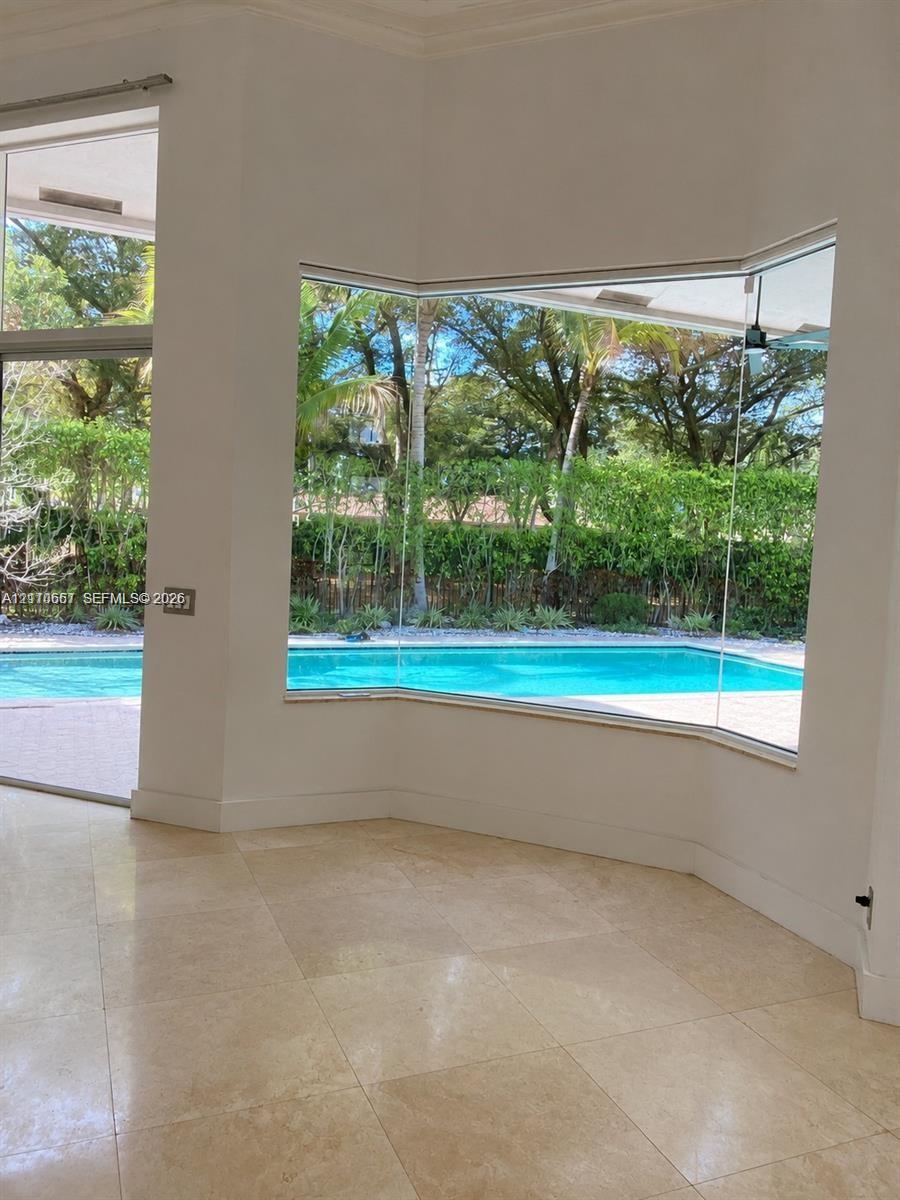 Vaulted ceiling, three arched windows, and wood-finish flooring