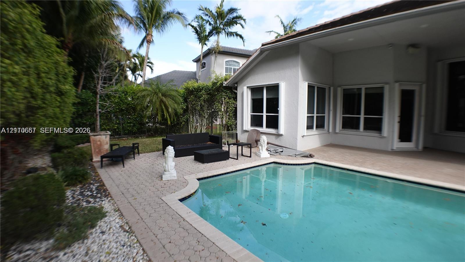 Covered patio featuring a paver deck, recessed lighting, ceiling fan, and access to an in-ground pool