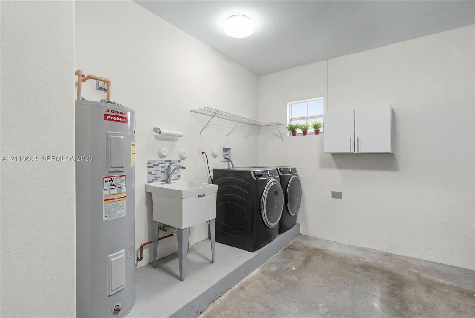 Laundry area with utility sink