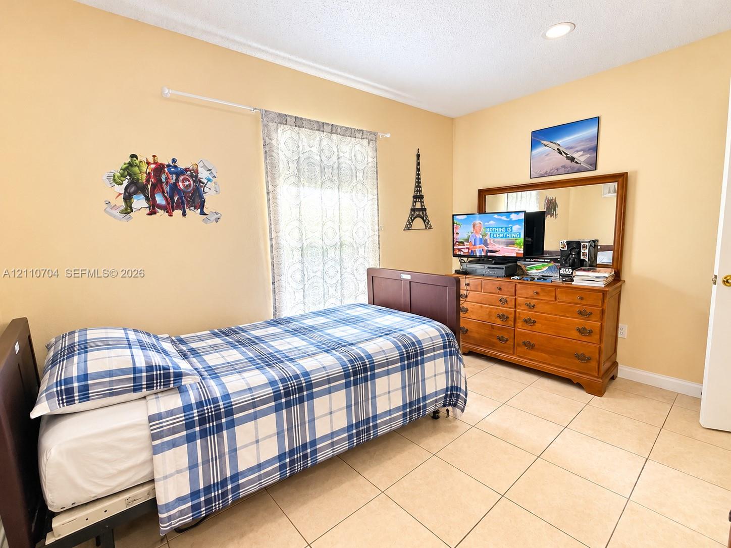 Interior room featuring large-format ceramic tile flooring, neutral wall paint, and recessed lighting