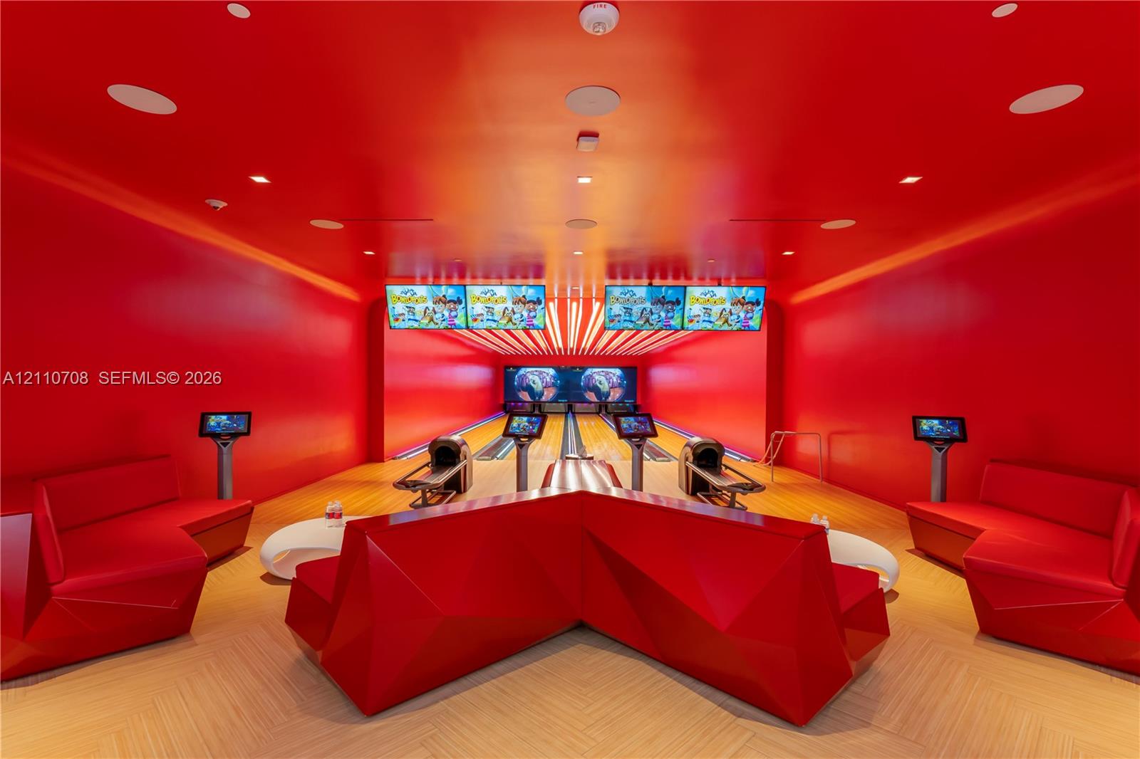 Private bowling alley featuring two lanes, built-in display screens, integrated ceiling lighting, and chevron-patterned wood-finish flooring Private bowling alley featuring two lanes, built-in display screens, integrated ceiling lighting, and chevron-patterned wood-finish flooring