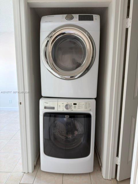 Stacked, front-loading washer and dryer unit housed in a dedicated closet Stacked, front-loading washer and dryer unit housed in a dedicated closet