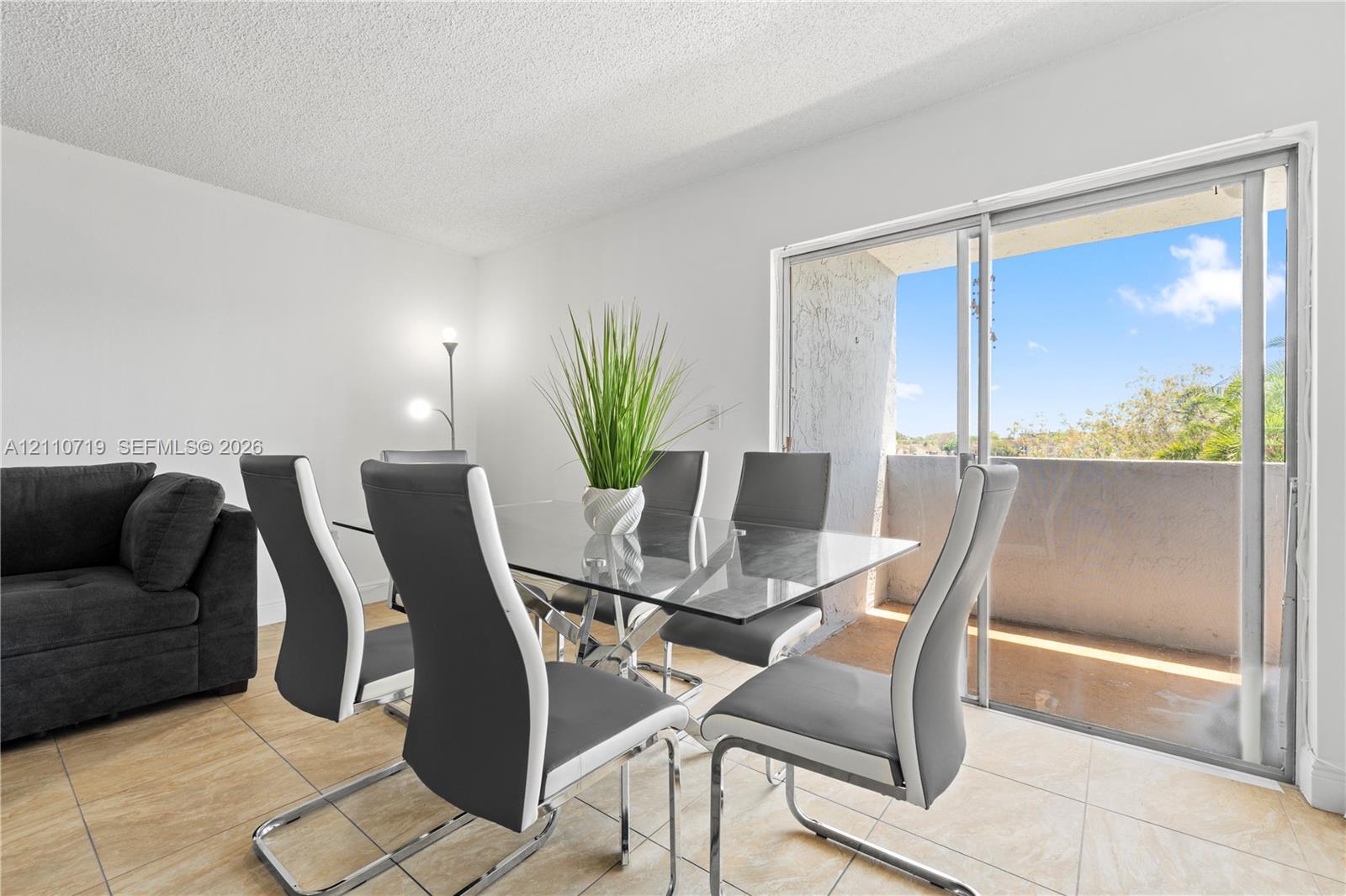 Ceramic tile flooring, sliding glass door, and private exterior balcony