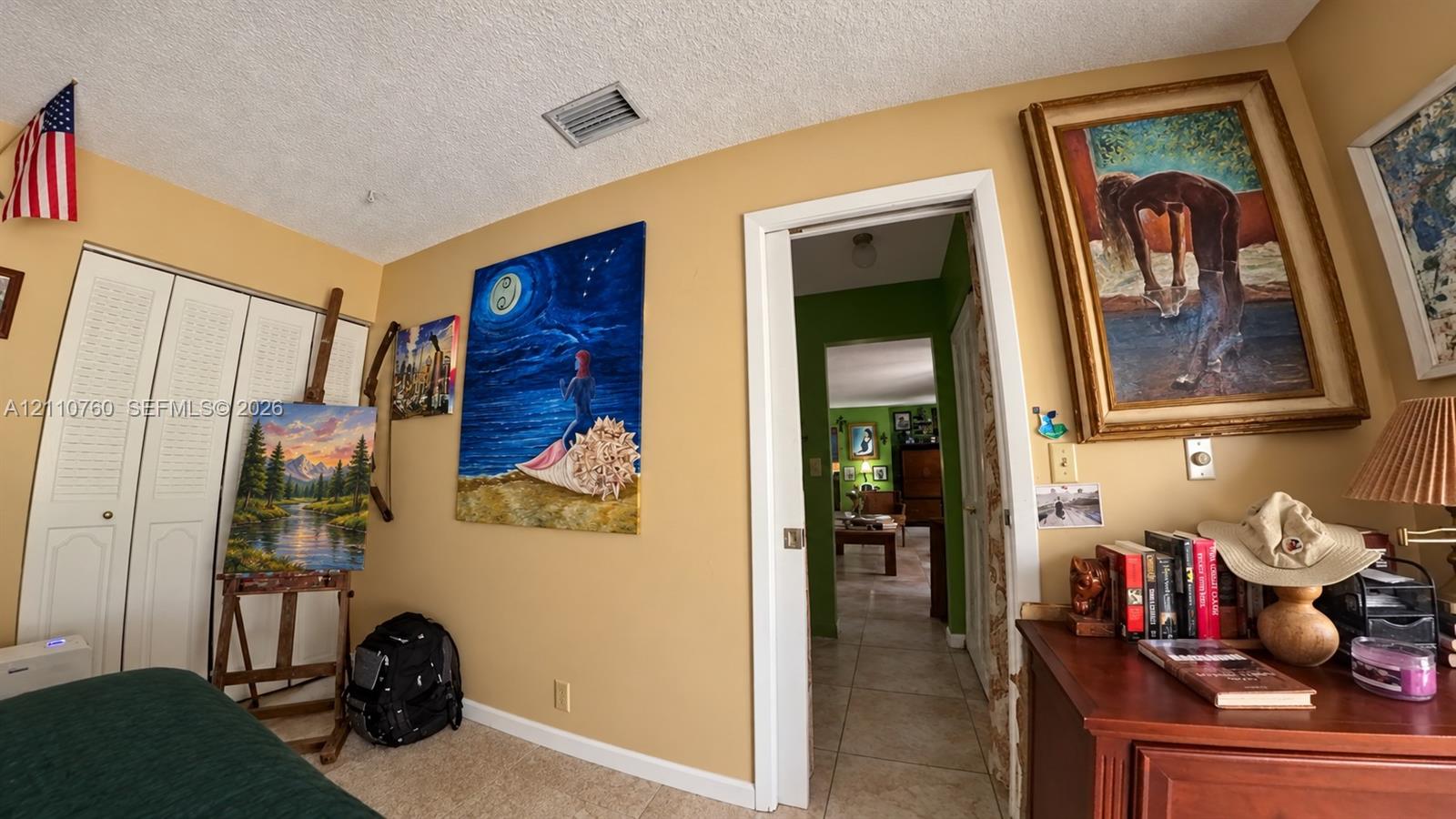 Interior space featuring tile flooring and bi-fold closet doors