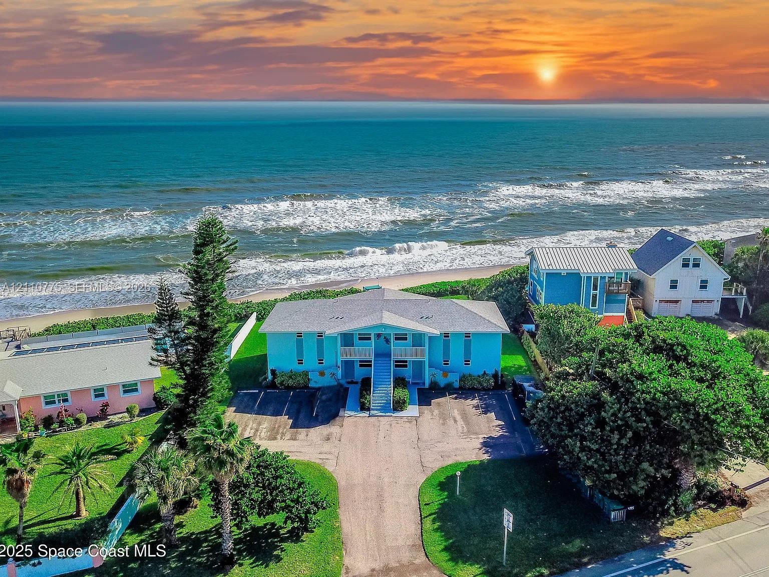 Direct oceanfront property featuring a paved driveway, elevated entryway, multi-level exterior, and coastal landscaping Direct oceanfront property featuring a paved driveway, elevated entryway, multi-level exterior, and coastal landscaping