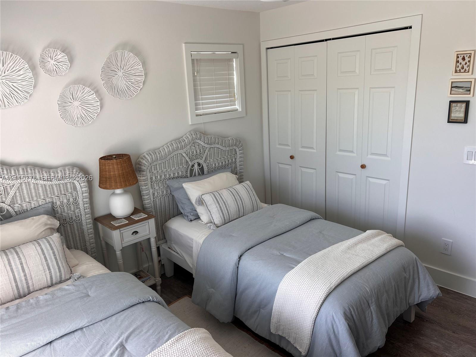 Neutral wall finish, double-panel closet doors, and wood-finish flooring