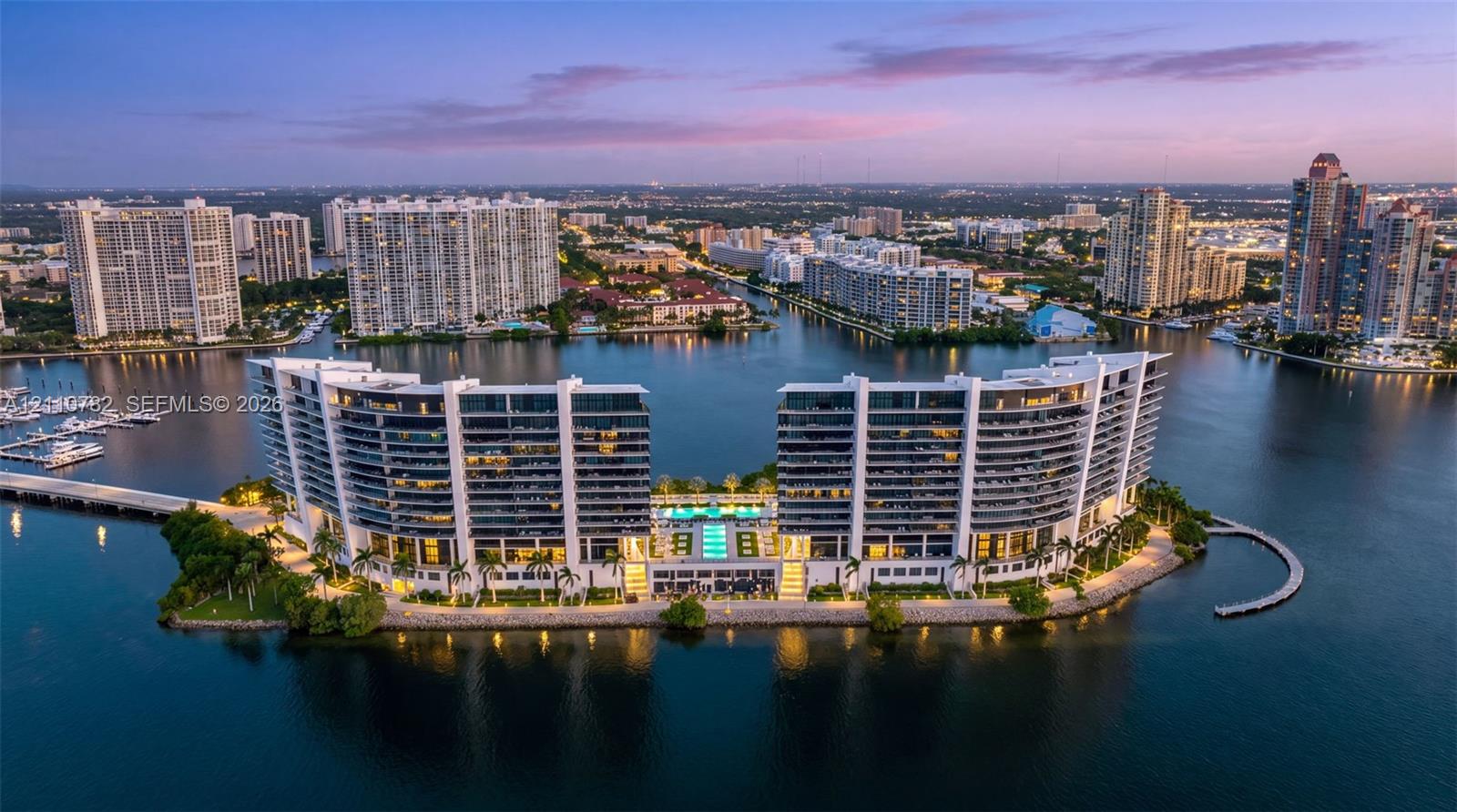 Waterfront high-rise complex featuring private swimming pools, palm-lined landscaping, and deep-water marina access Waterfront high-rise complex featuring private swimming pools, palm-lined landscaping, and deep-water marina access