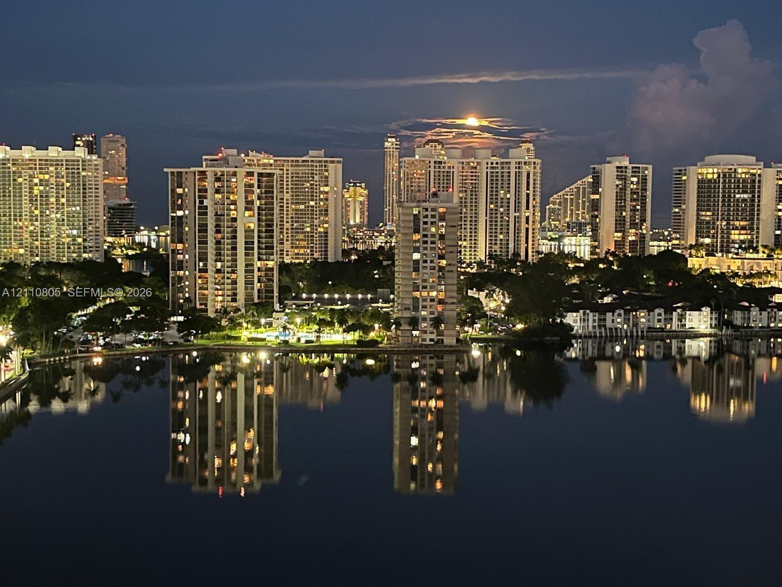 Elevated perspective of the urban skyline and expansive waterfront with reflections Elevated perspective of the urban skyline and expansive waterfront with reflections