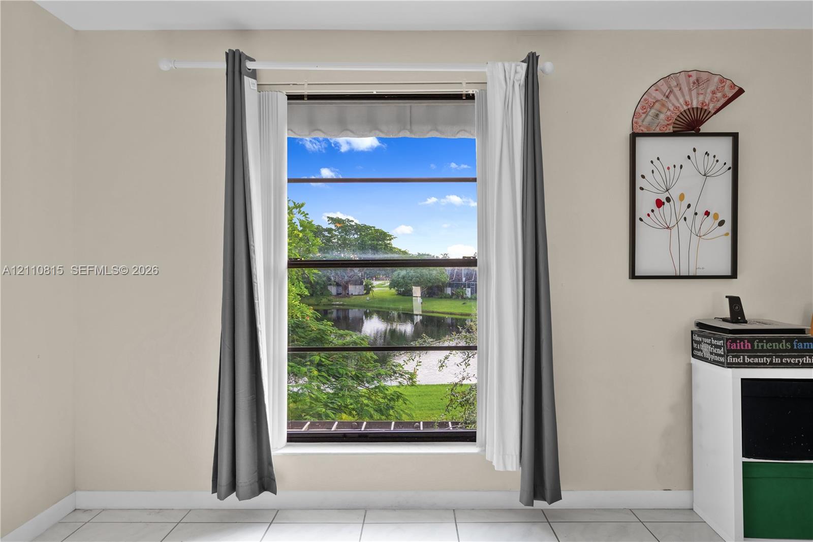 Single-pane window featuring a landscape exposure of a water feature and surrounding foliage