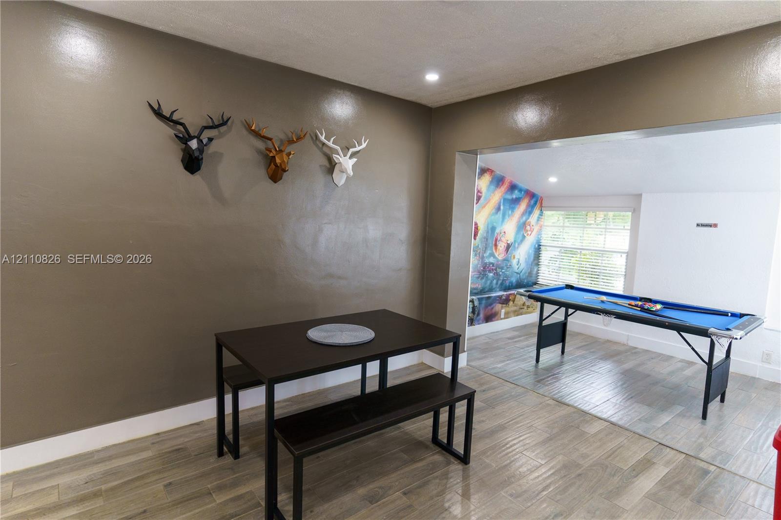 Interior space featuring wood-finish tile flooring and recessed lighting