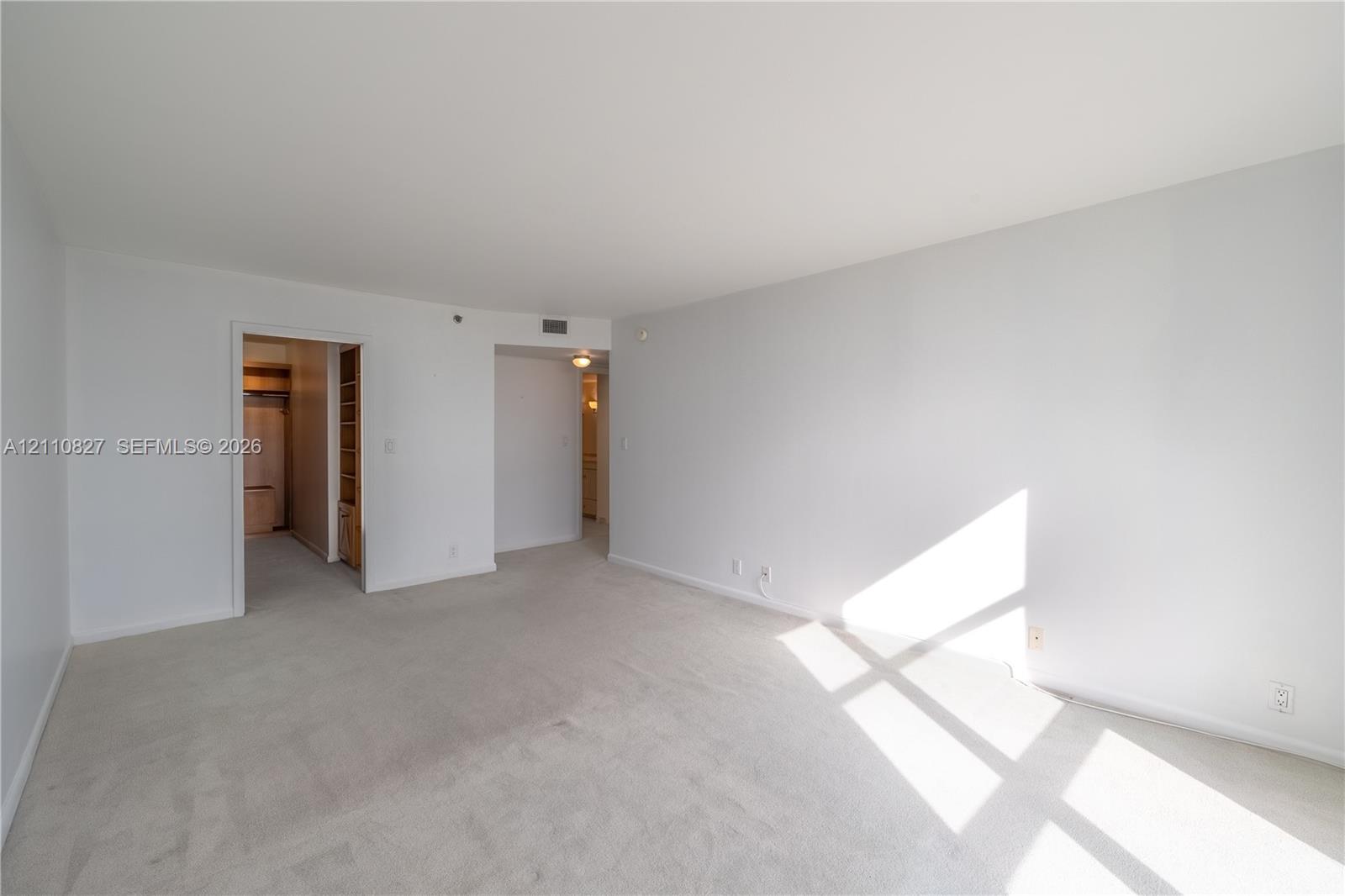 Neutral-toned wall paint, neutral carpeting, and recessed ceiling lighting