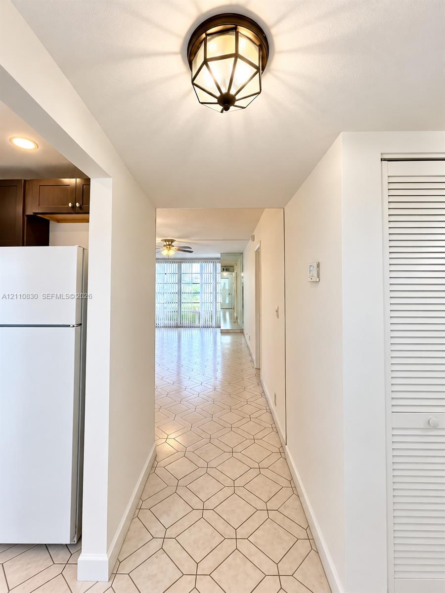 Geometric patterned tile flooring, hexagonal light fixture with oil-rubbed bronze finish, and louvered bifold closet doors Geometric patterned tile flooring, hexagonal light fixture with oil-rubbed bronze finish, and louvered bifold closet doors