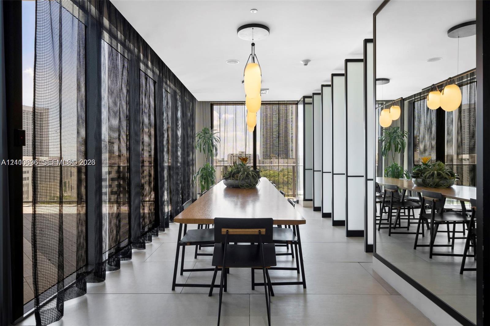 Floor-to-ceiling glass walls, large-format tile flooring, modern architectural wall panels, and suspended globe pendant lighting