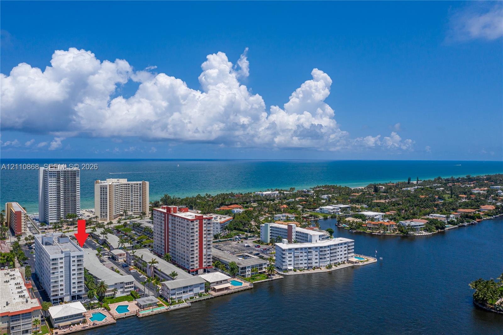 Aerial perspective of coastal residential property featuring proximity to the shoreline, direct water access, and exterior swimming pool facilities