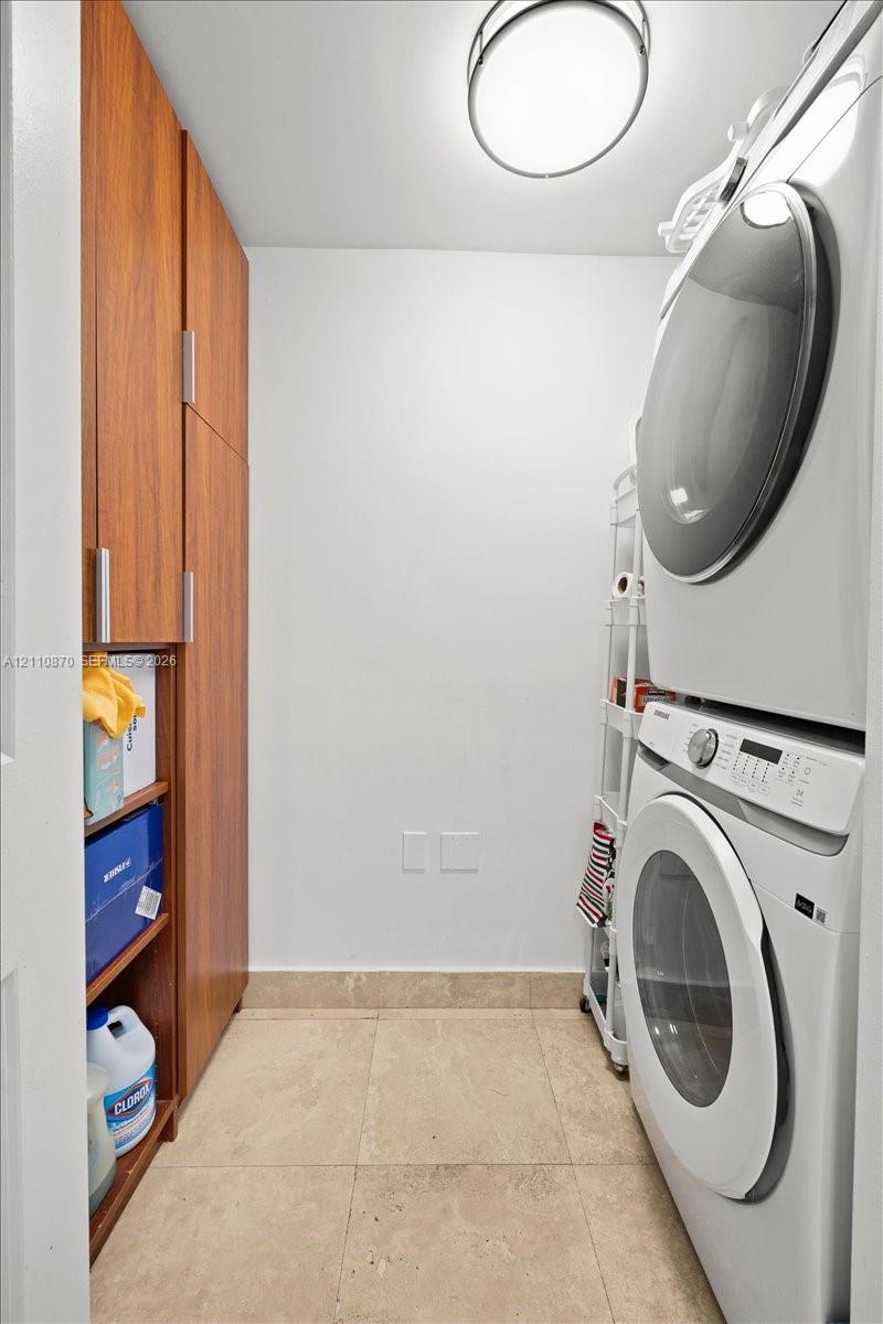 Built-in floor-to-ceiling wood-finish cabinetry, tile flooring, and flush-mount overhead lighting