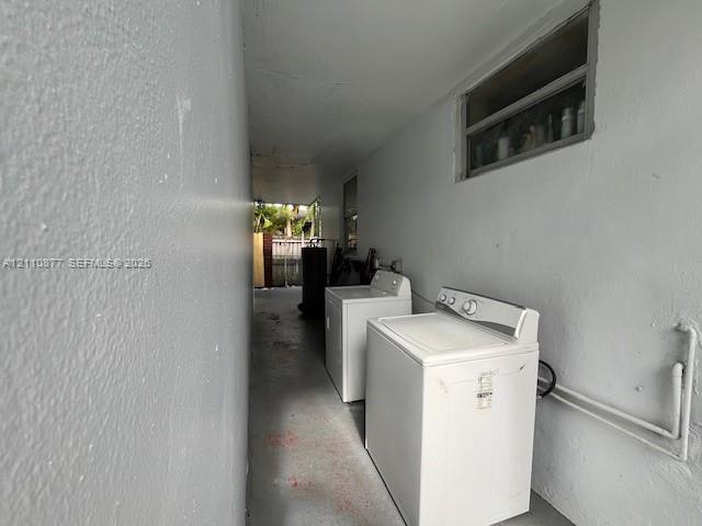 Covered exterior utility area featuring concrete flooring, smooth wall finishes, and a horizontal sliding window
