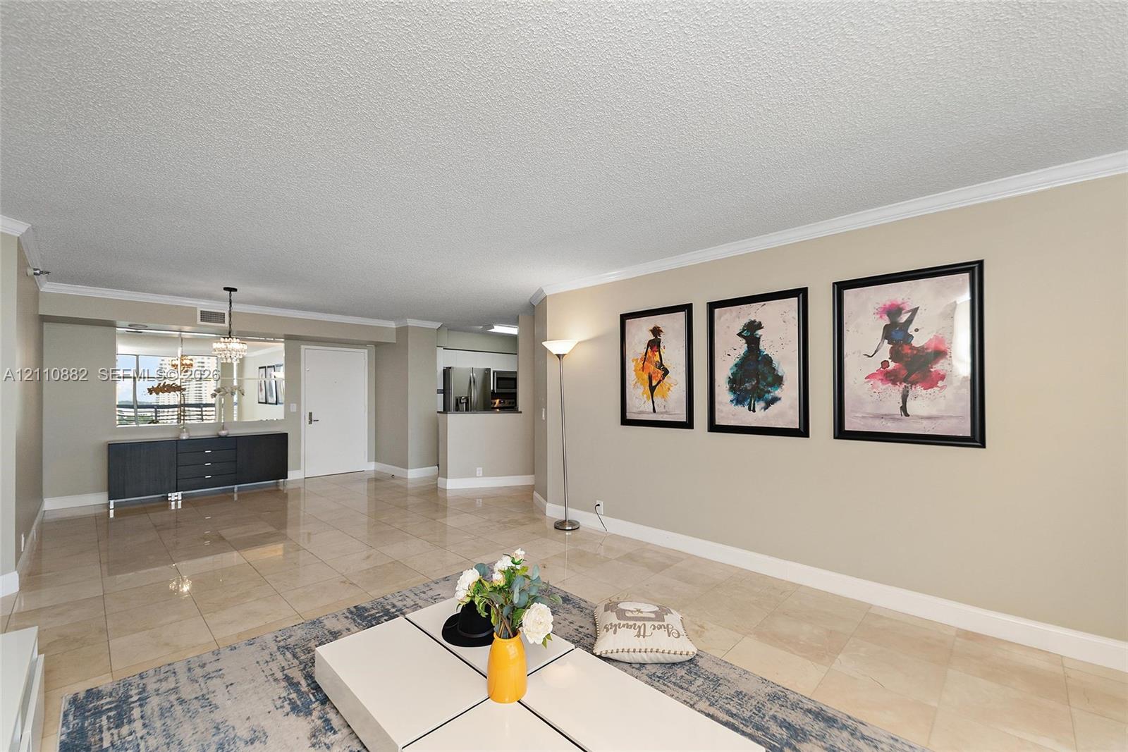 Polished tile flooring, crown molding, and a built-in wall-to-wall mirror Polished tile flooring, crown molding, and a built-in wall-to-wall mirror