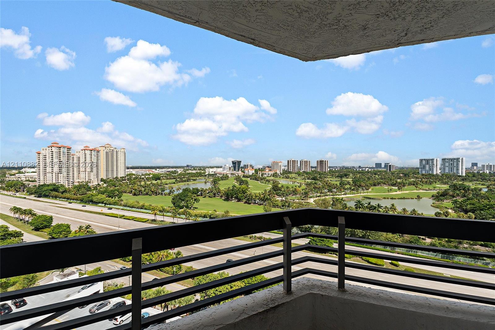 Covered balcony featuring a matte black horizontal railing and concrete ceiling Covered balcony featuring a matte black horizontal railing and concrete ceiling