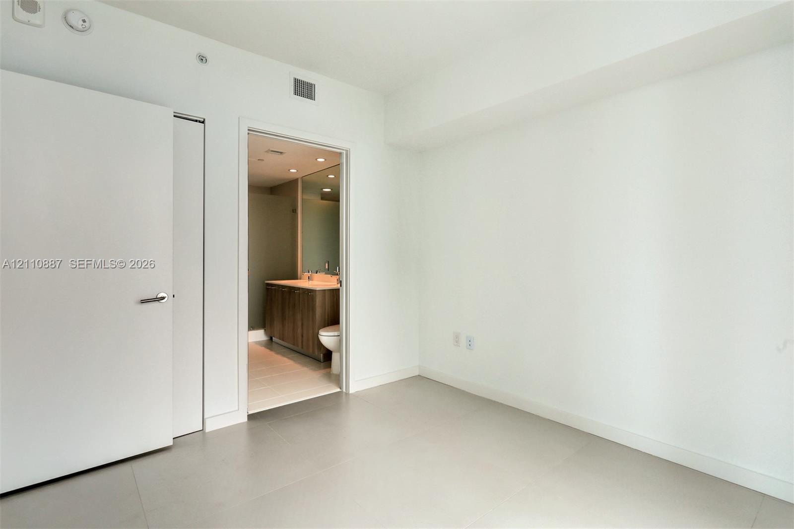 Neutral wall palette with porcelain tile flooring