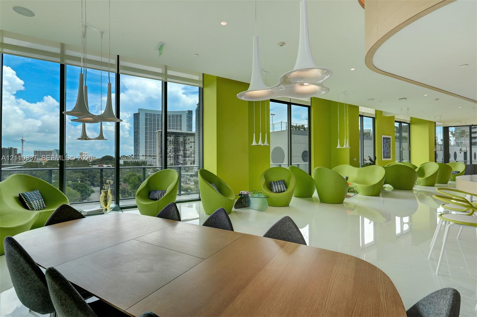 Floor-to-ceiling windows, high-gloss white flooring, contemporary pendant lighting, and a curved architectural wall feature