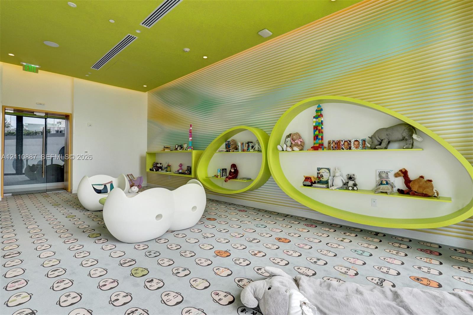 Custom oval-shaped built-in shelving, textured wall paneling, and recessed ceiling lighting