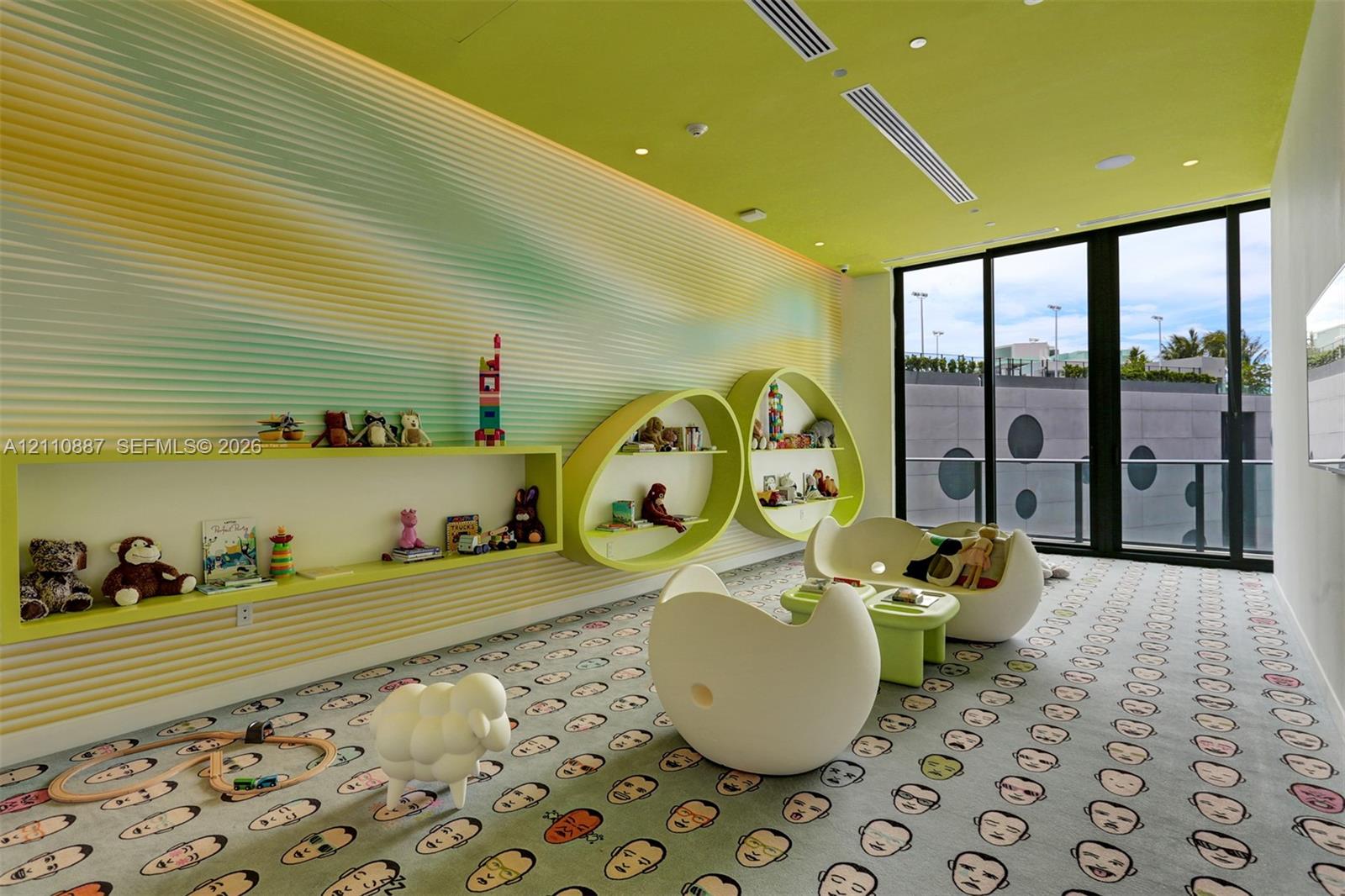 Custom interior space featuring large floor-to-ceiling windows, built-in oval and rectangular shelving, and recessed ceiling lighting