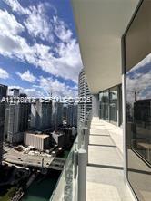 Covered balcony featuring glass paneled railings, concrete flooring, and floor-to-ceiling glass wall enclosures