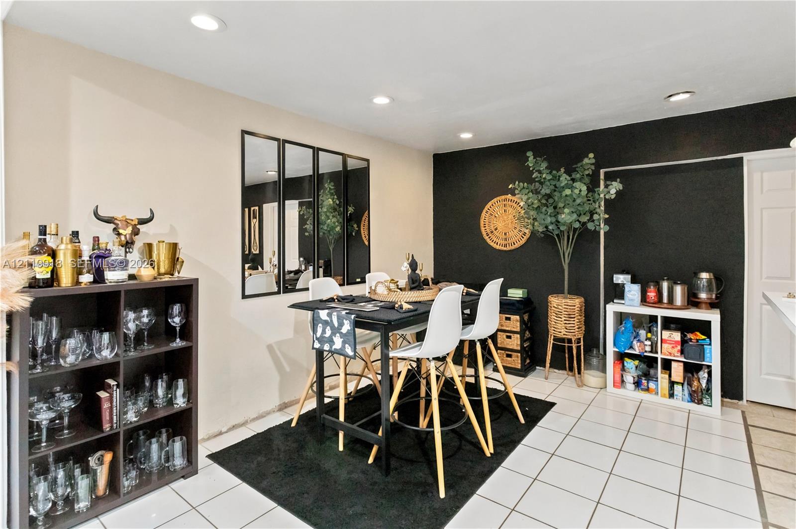Ceramic tile flooring, recessed ceiling lighting, and a multi-panel wall mirror