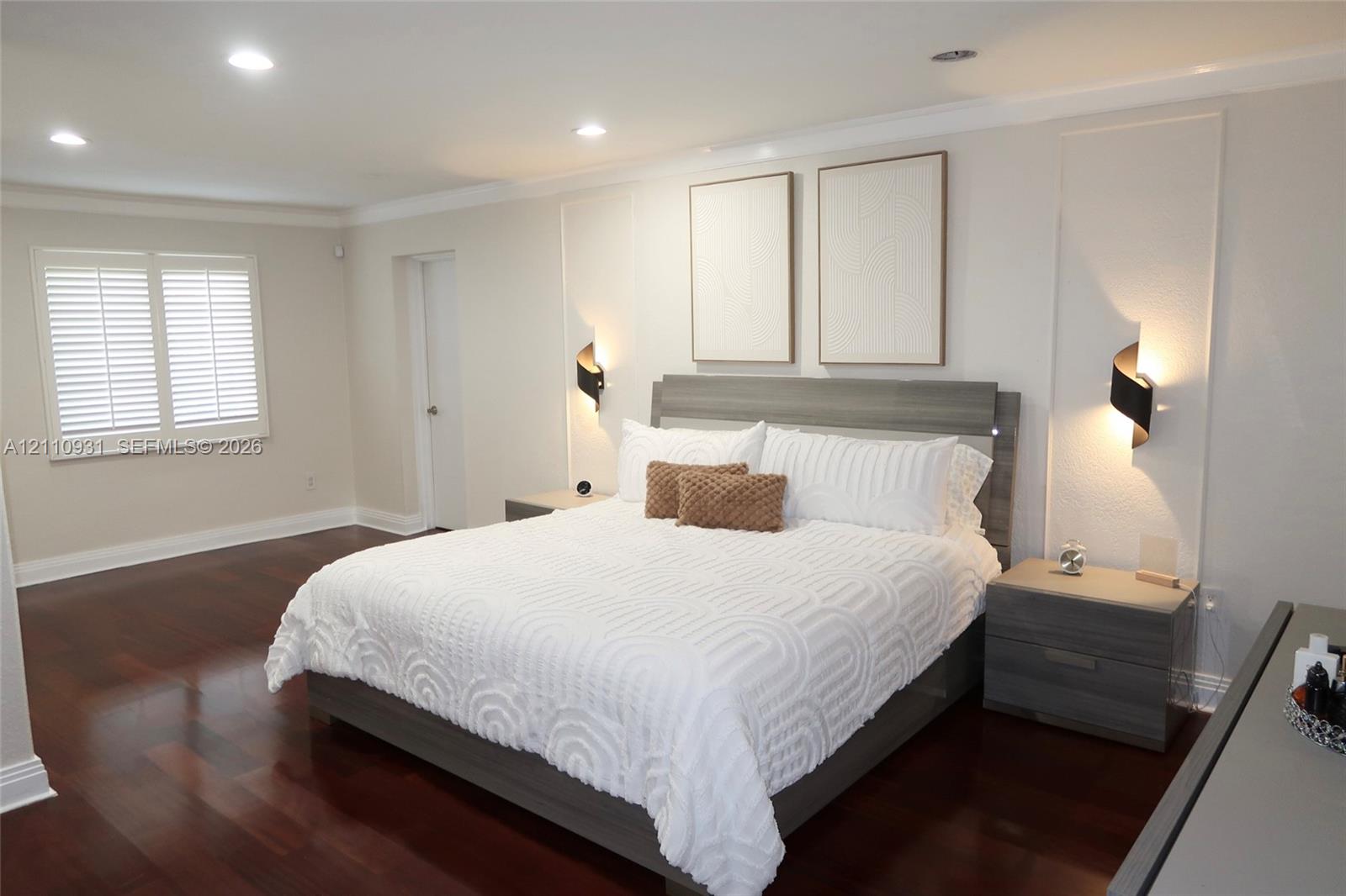 Hardwood flooring, recessed lighting, wall-mounted accent lighting, framed wall paneling, and shutter-style window coverings
