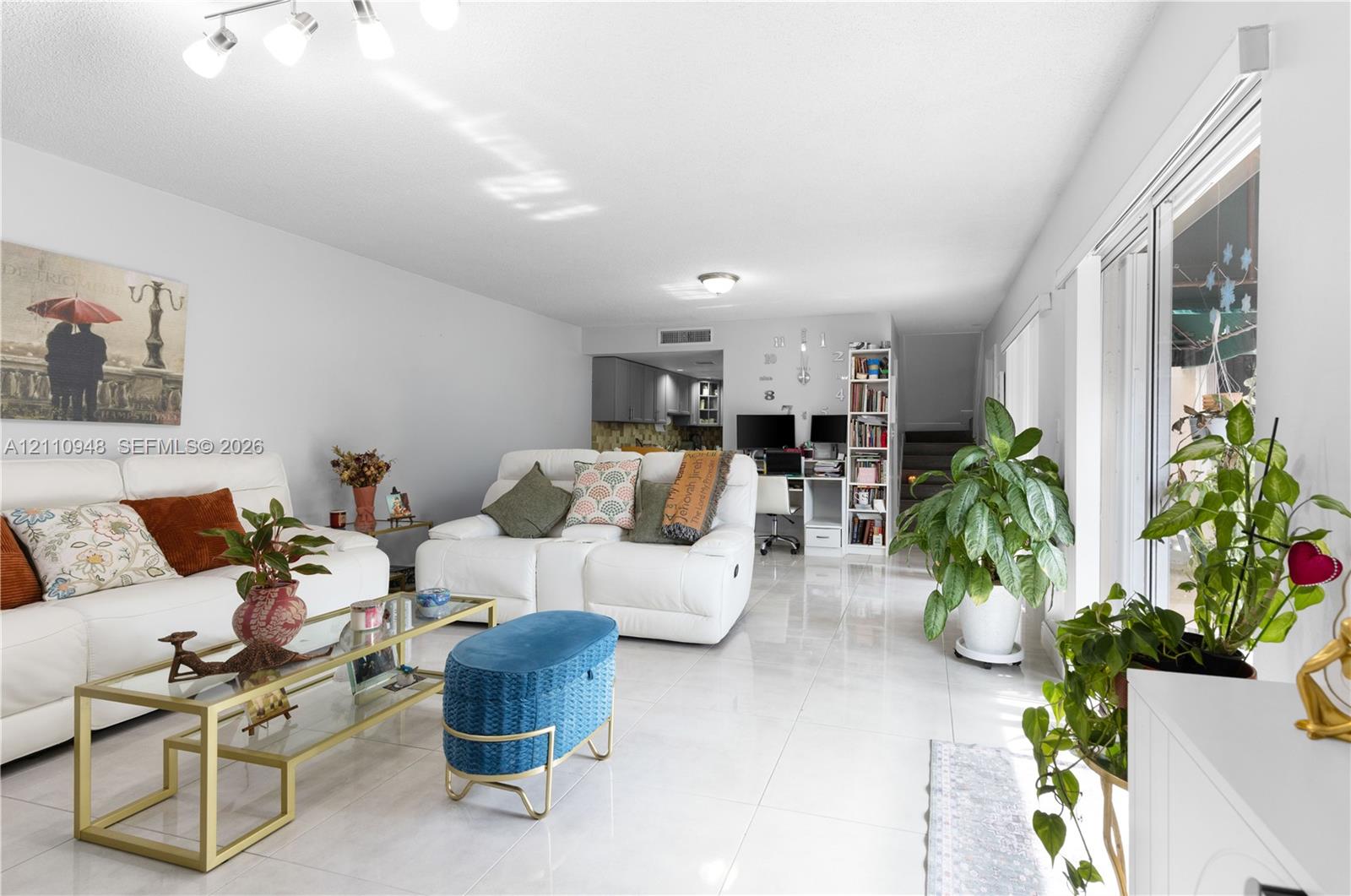 Polished tile flooring, recessed lighting, and sliding glass doors featuring exterior access