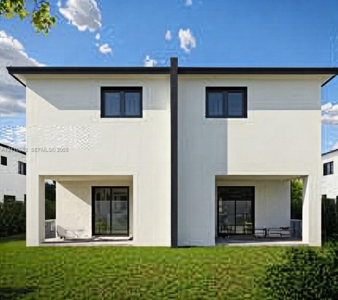 Two-story duplex exterior featuring smooth-finish light-colored cladding, dual ground-level covered patios, dark-framed sliding glass doors, and dark-framed windows