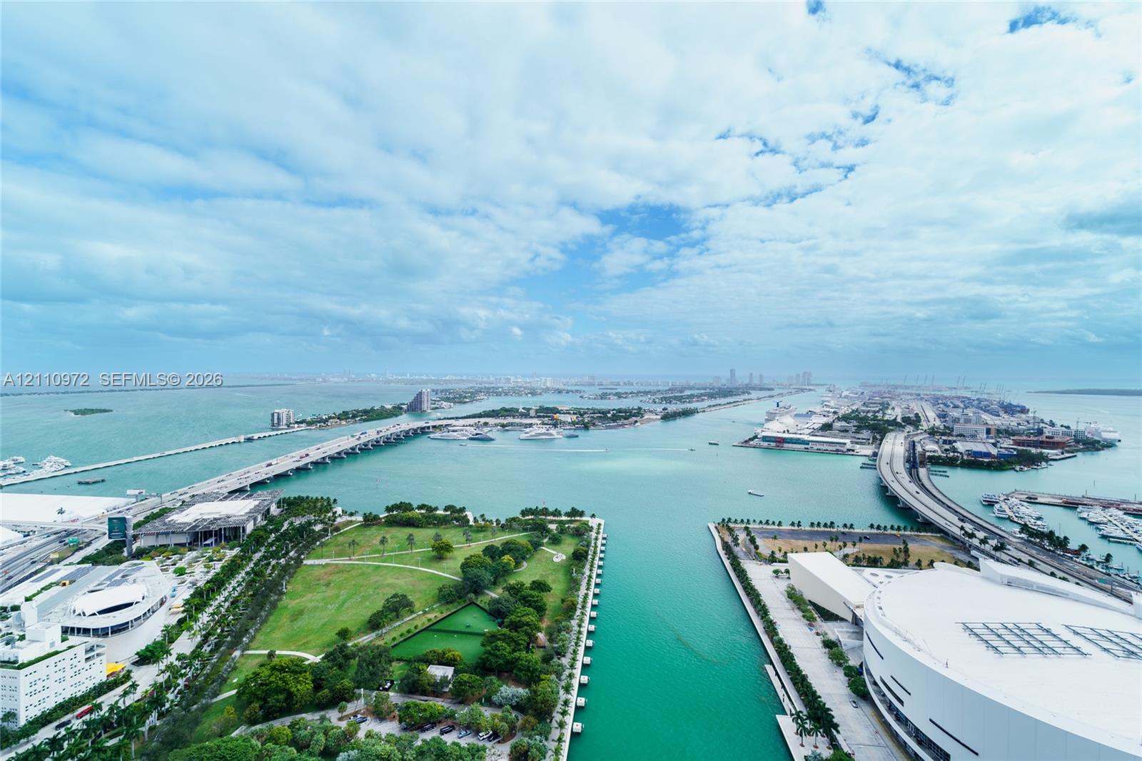 Aerial perspective showcasing expansive water frontage, multiple bridge spans, an urban park, and harbor proximity Aerial perspective showcasing expansive water frontage, multiple bridge spans, an urban park, and harbor proximity