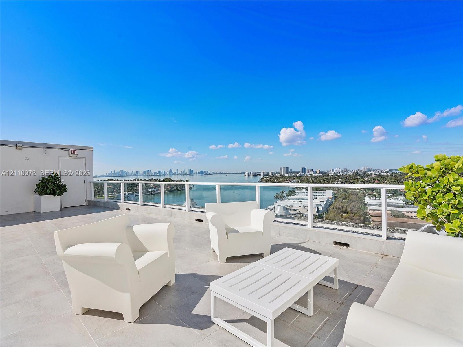 Expansive rooftop terrace featuring large-format tile flooring and a white powder-coated railing