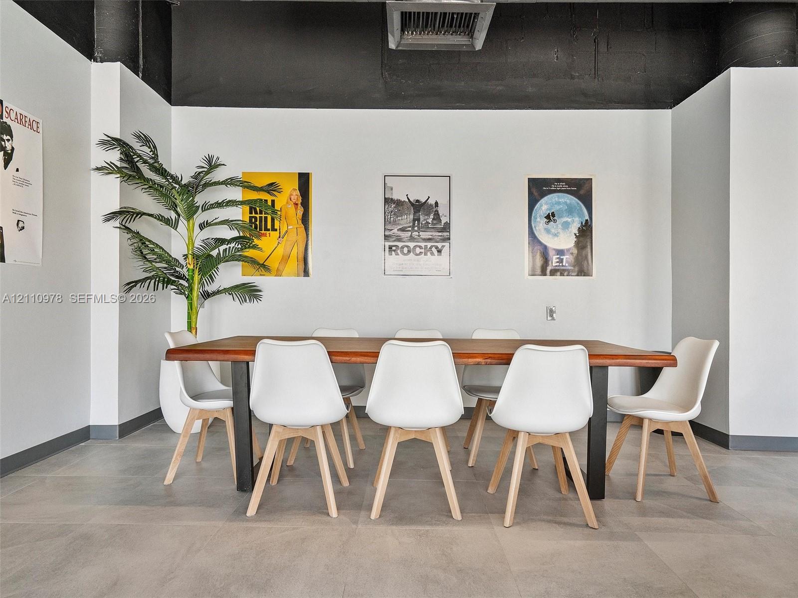 Large-format tile flooring, high exposed ceilings with matte black finish, and industrial-style painted wall accents