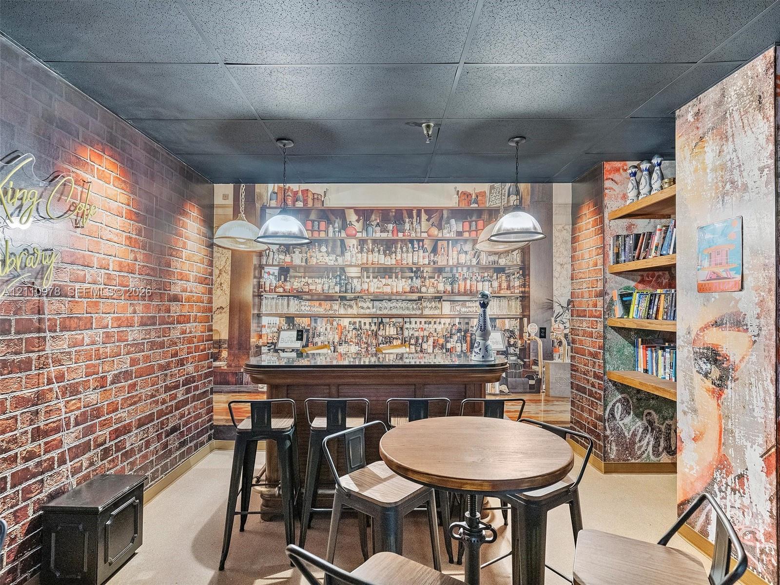 Built-in bar featuring a stone-finish countertop, pendant lighting, textured brick-style walls, and integrated wood shelving
