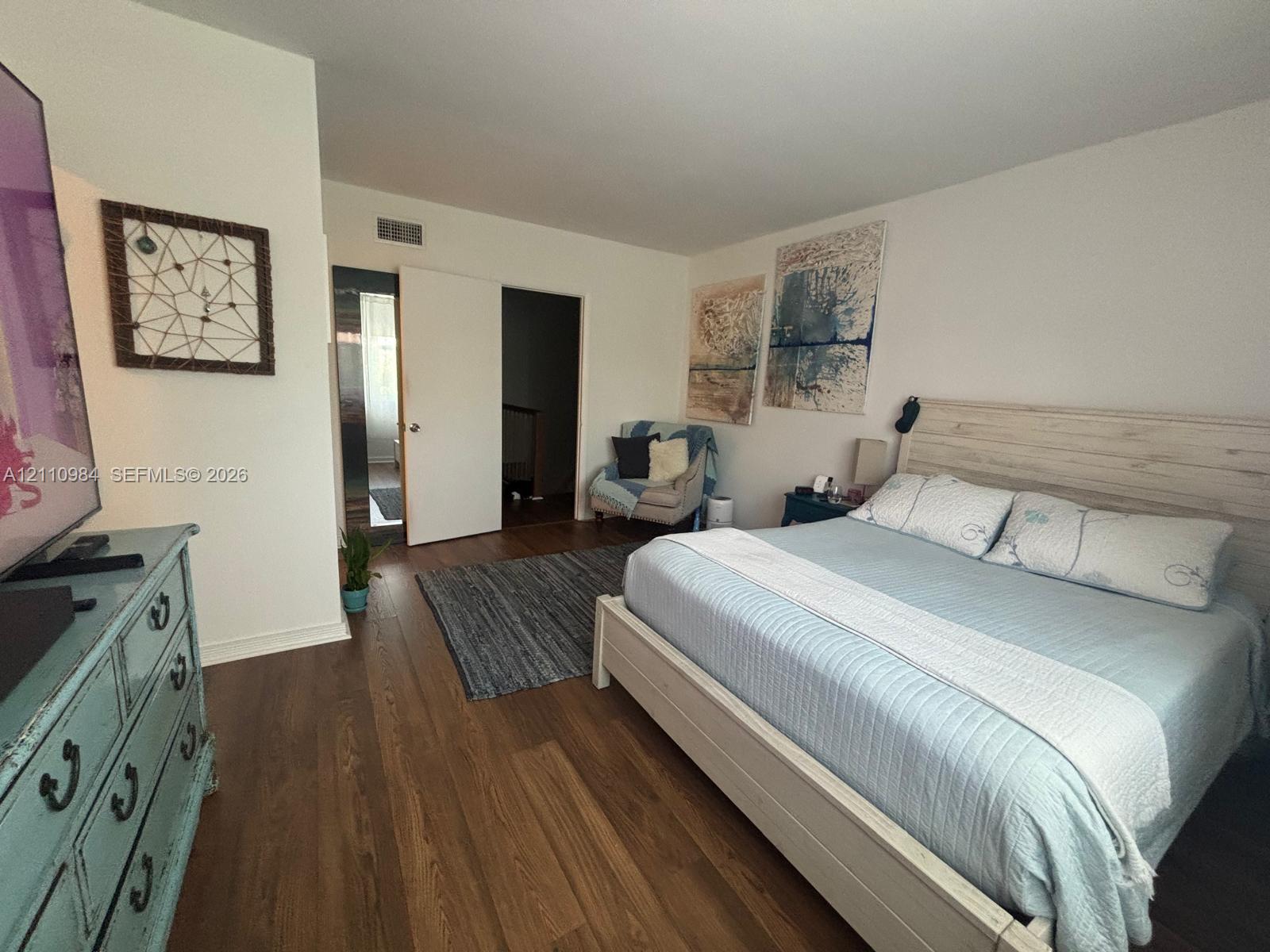 Spacious interior featuring wood-finish flooring and smooth-finish walls