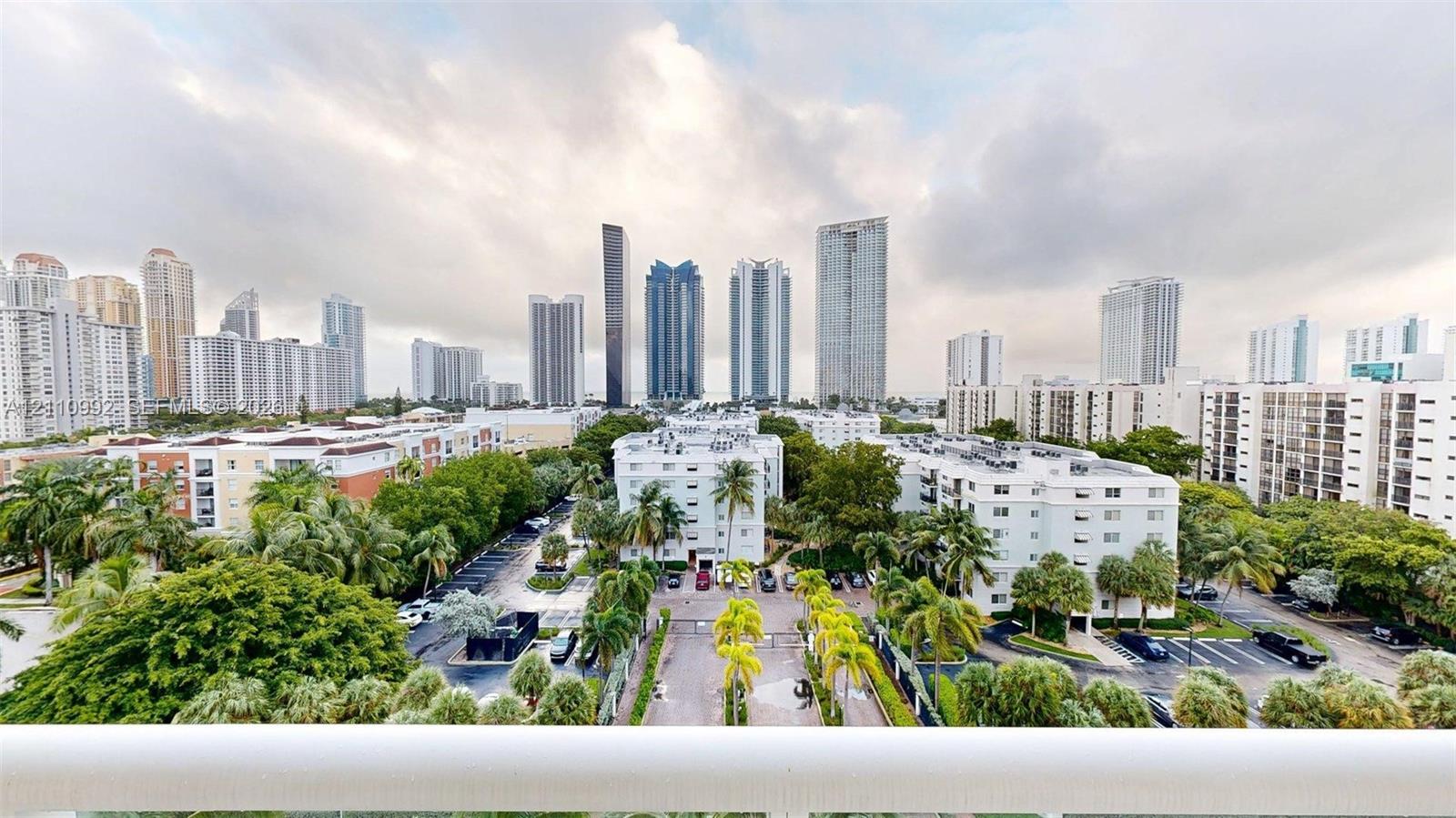 Elevated balcony featuring a white railing and expansive skyline scenery