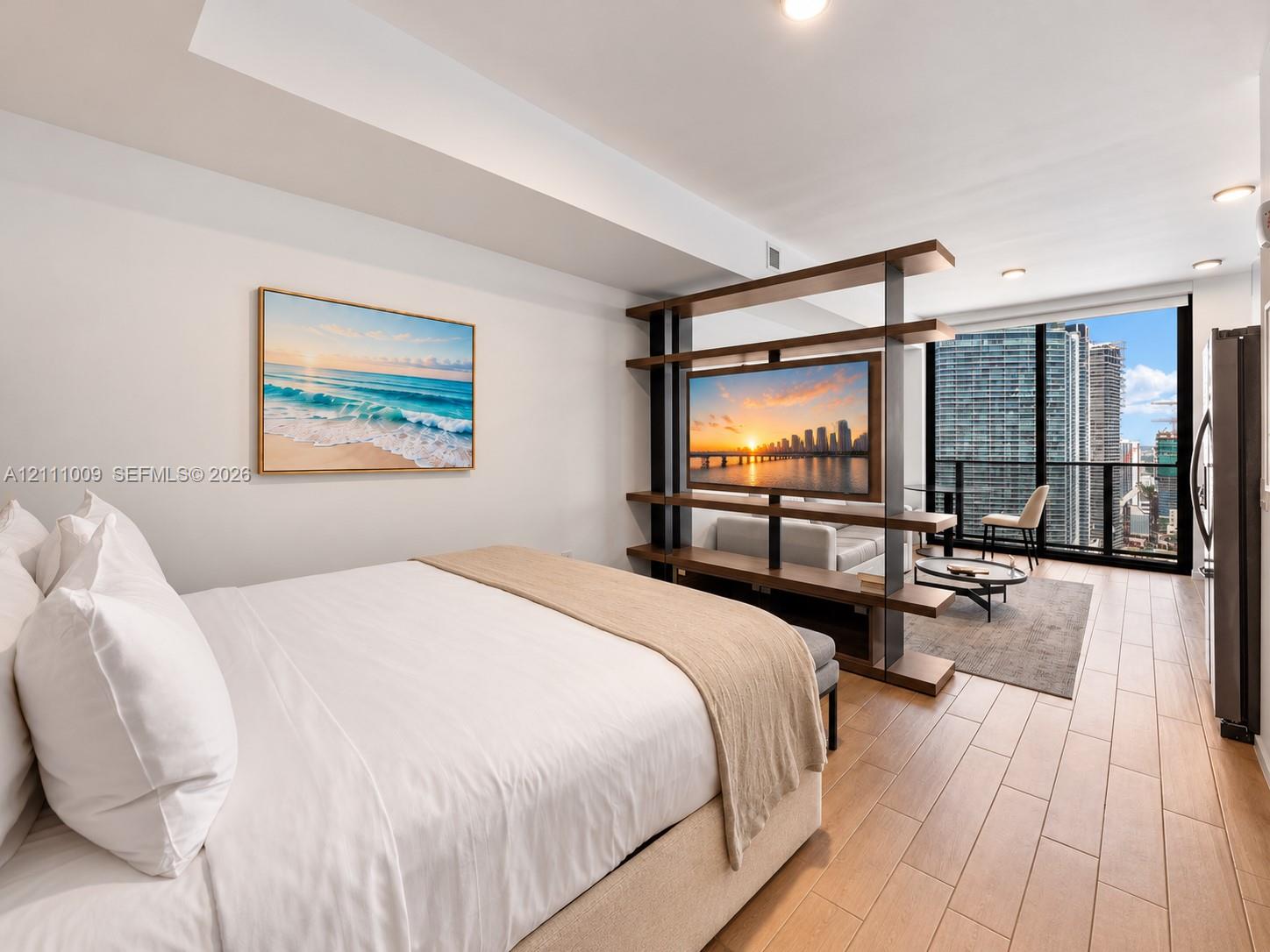 Wood-finish tile flooring, floor-to-ceiling windows, recessed lighting, and a custom built-in room divider