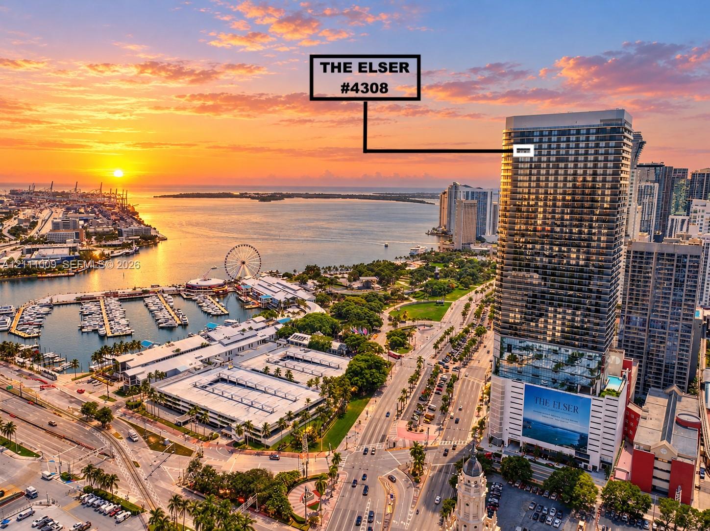 High-rise residential tower featuring a glass facade and an elevated outdoor swimming pool with expansive waterfront and cityscape panoramas