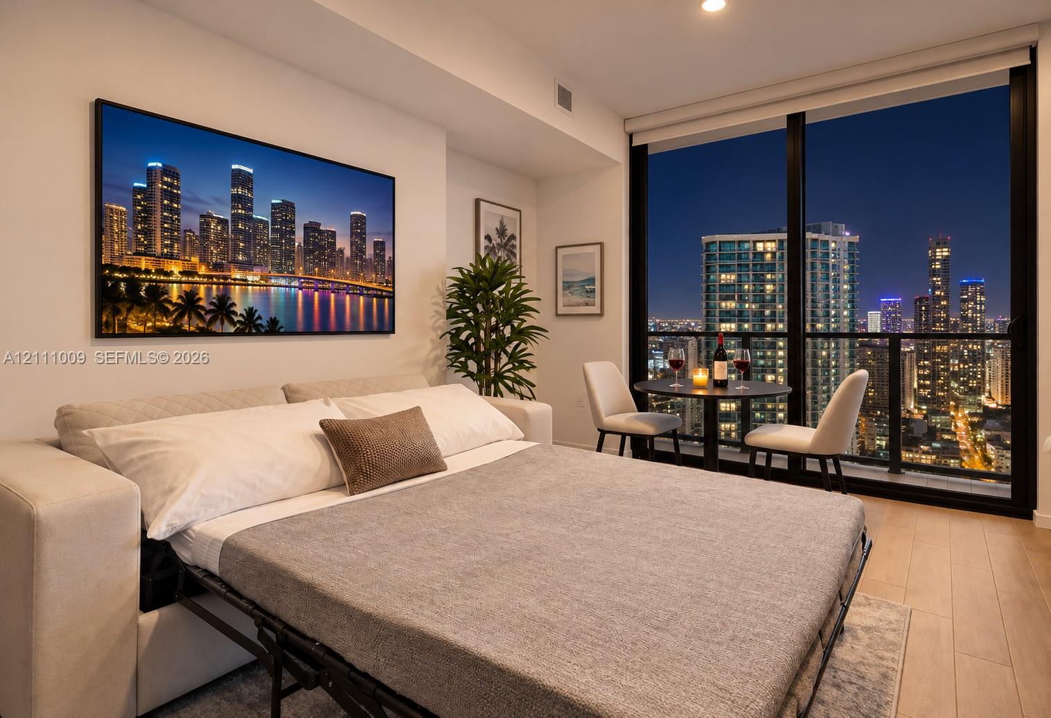 Floor-to-ceiling windows, wood-finish flooring, and recessed lighting