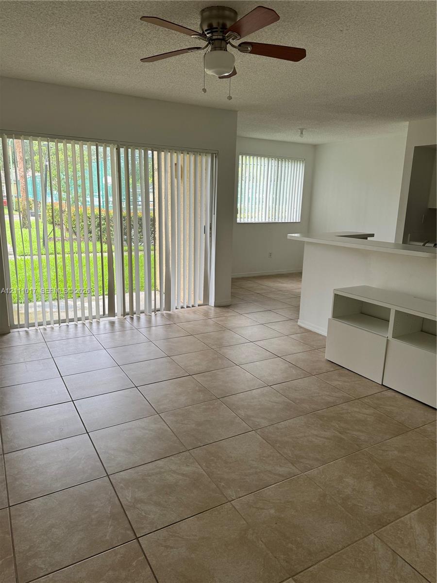 Ceramic tile flooring, sliding glass patio door, built-in breakfast bar, and ceiling fan Ceramic tile flooring, sliding glass patio door, built-in breakfast bar, and ceiling fan