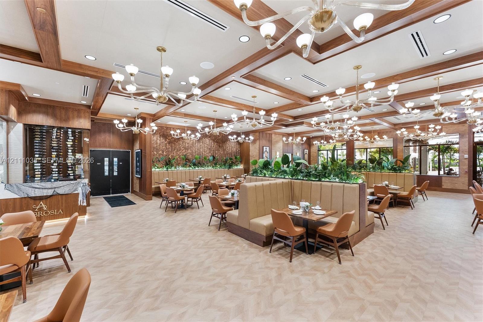 Coffered wood-beam ceilings, multiple multi-tiered chandeliers, integrated wine storage, herringbone-pattern flooring, and built-in booth seating