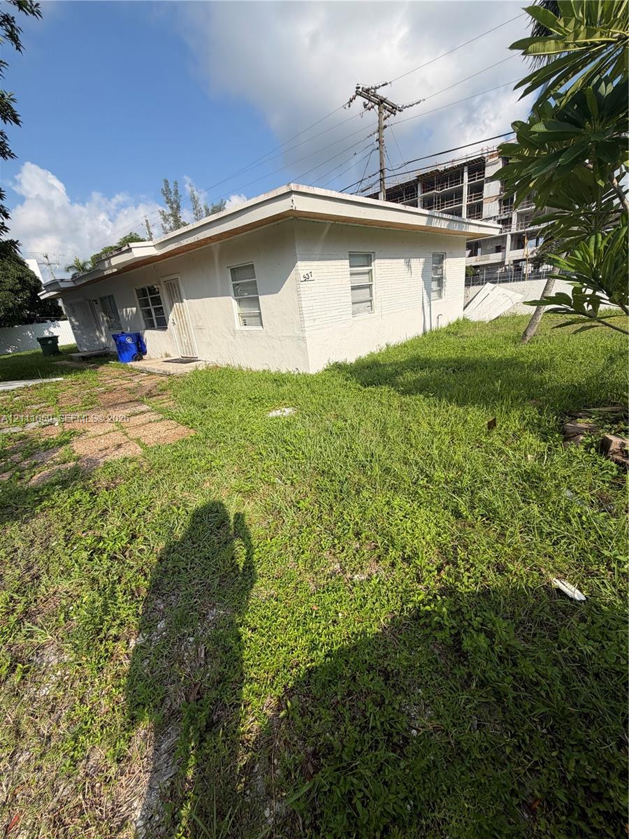 Single-story structure with a flat roof, white exterior finish, and horizontal sliding windows