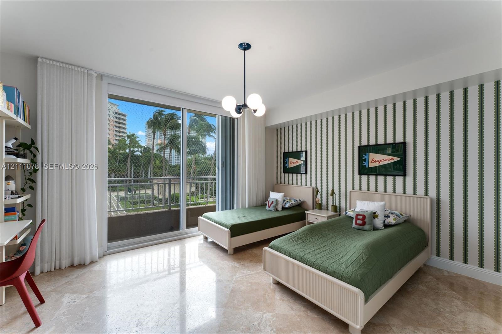 Polished stone flooring, floor-to-ceiling sliding glass doors, private balcony, built-in shelving, and designer chandelier