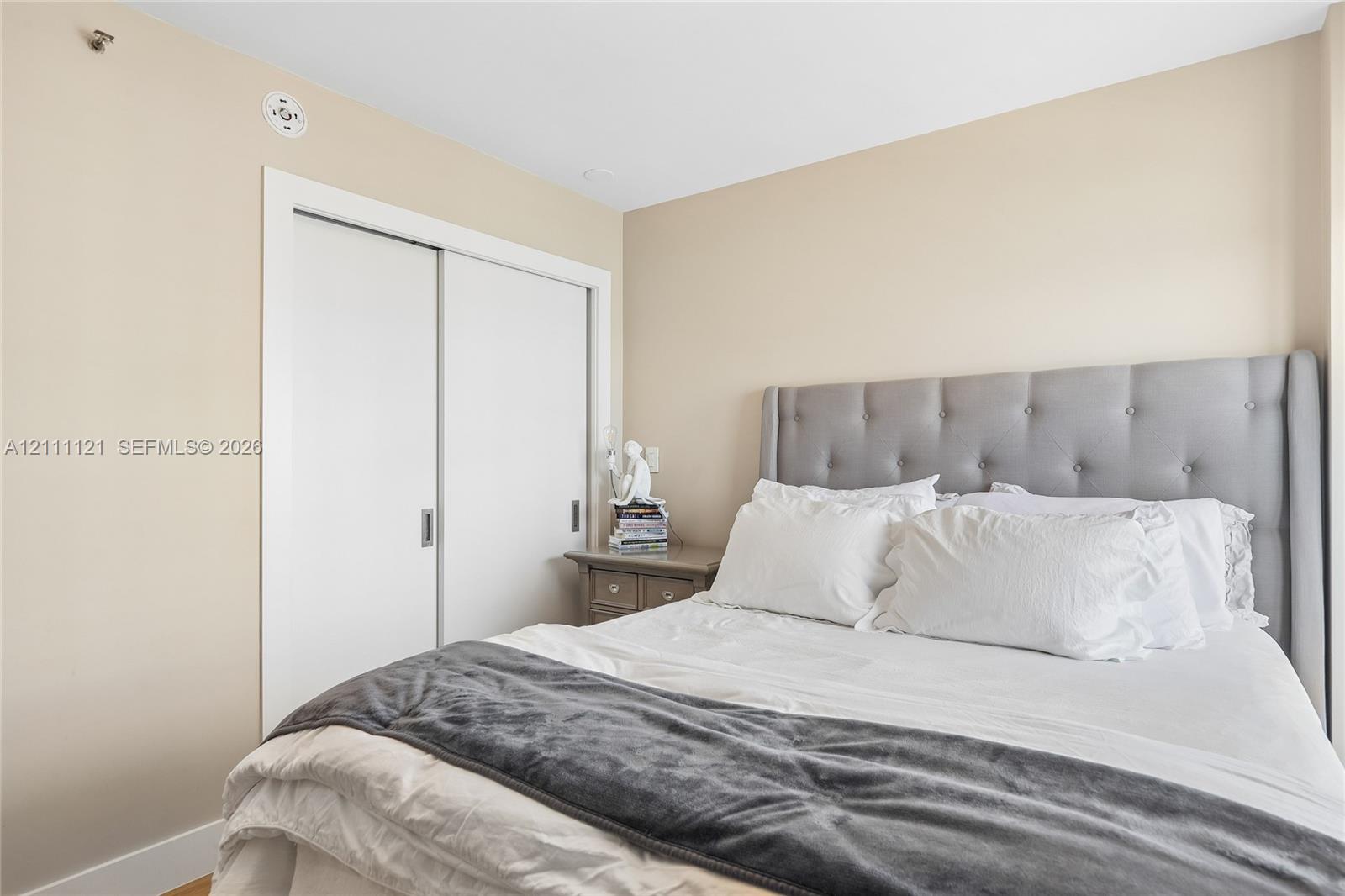 Neutral wall finishes and a built-in closet with sliding doors