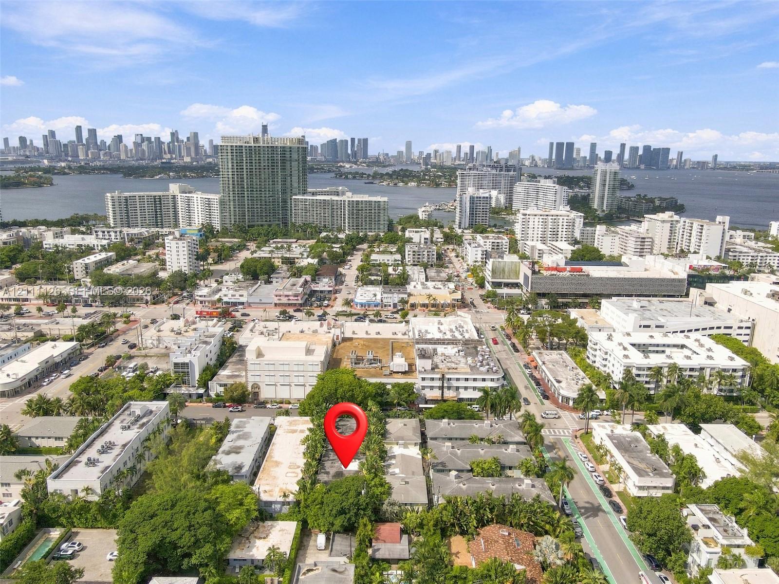 Aerial perspective of the property location featuring mature tree canopy, dense urban surroundings, and proximity to the waterfront