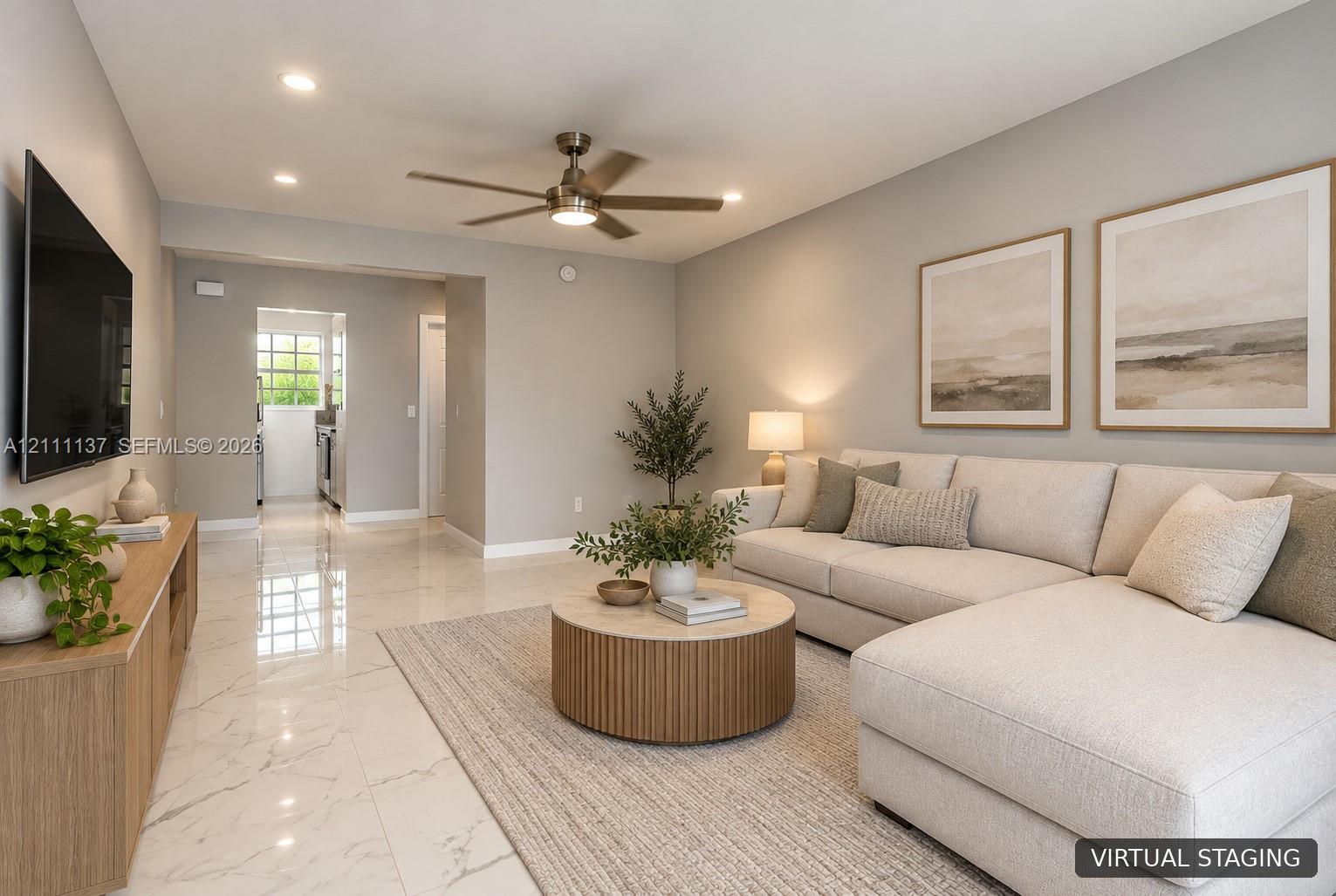 Living area featuring neutral wall paint, polished tile flooring, and a multi-blade ceiling fan with integrated lighting Living area featuring neutral wall paint, polished tile flooring, and a multi-blade ceiling fan with integrated lighting