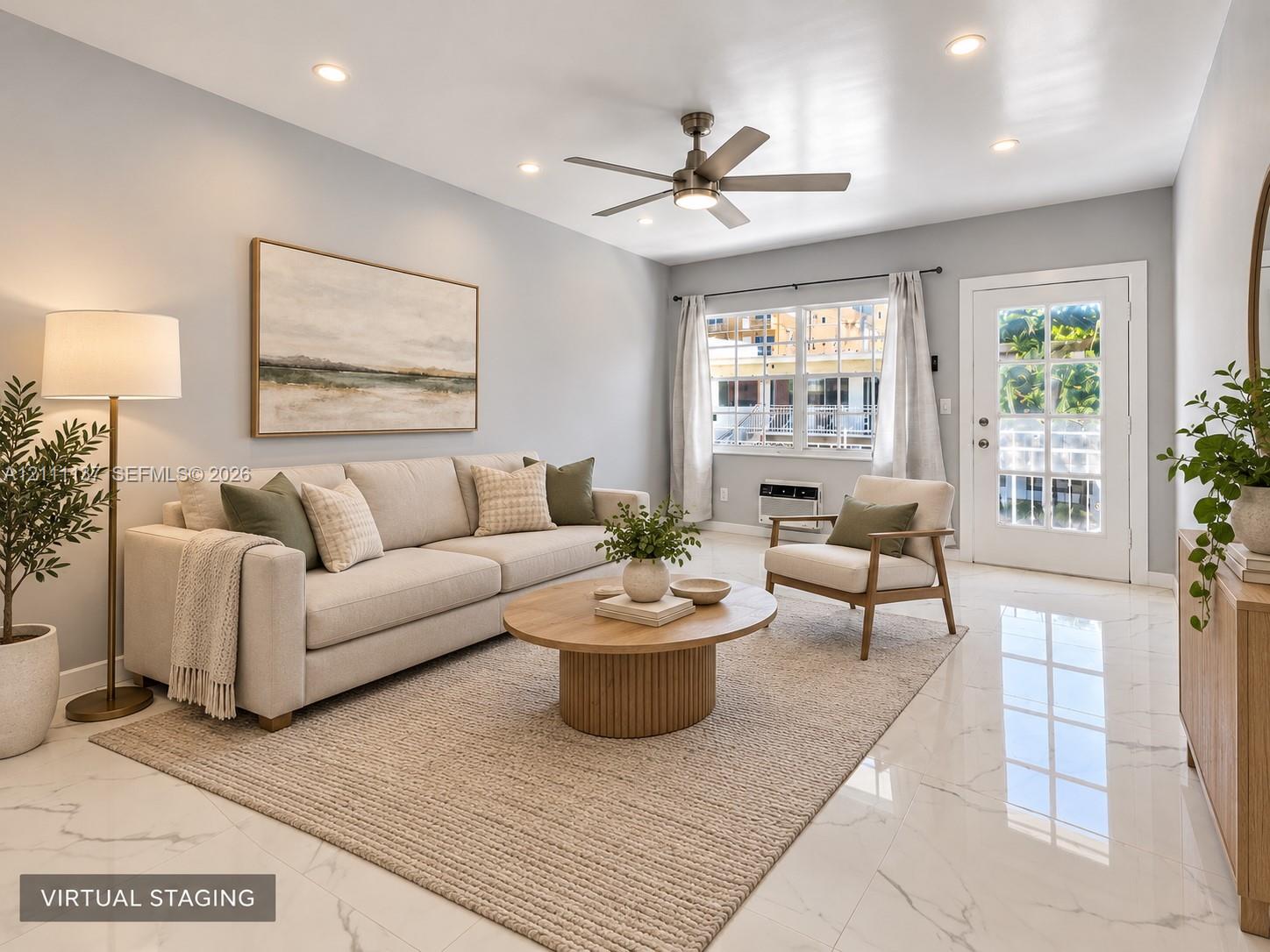 Neutral-toned interior featuring polished stone-finish flooring, recessed lighting, a brushed-nickel ceiling fan, and a glass-paneled exterior door Neutral-toned interior featuring polished stone-finish flooring, recessed lighting, a brushed-nickel ceiling fan, and a glass-paneled exterior door