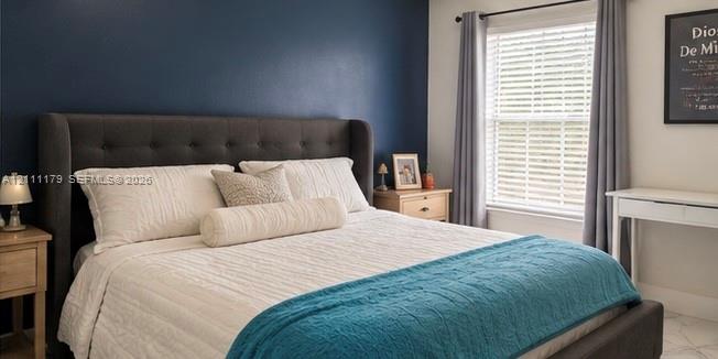 Accent wall in navy blue, large single-pane window with horizontal blinds, and tile flooring