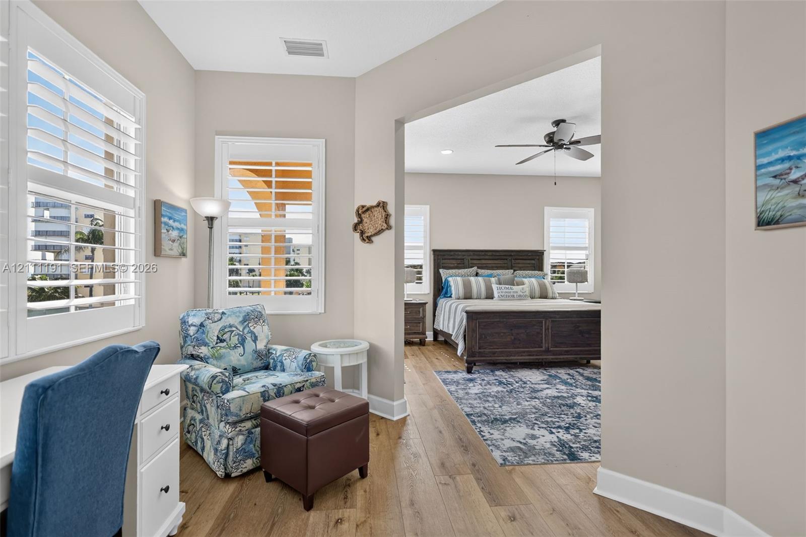 Wood-finish flooring, plantation shutters, recessed lighting, and a ceiling fan